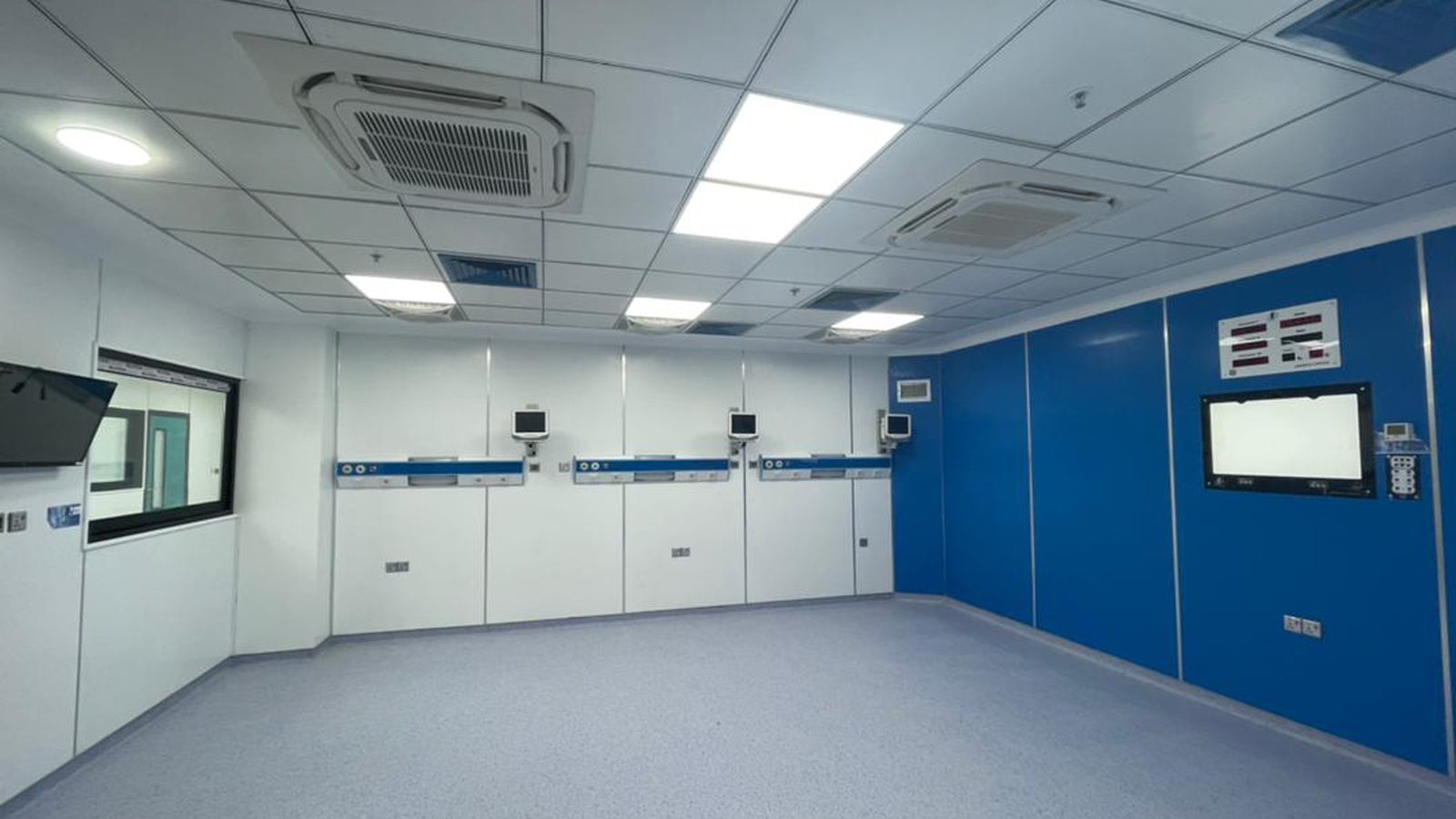 Hospital room with white and blue modular wall panels