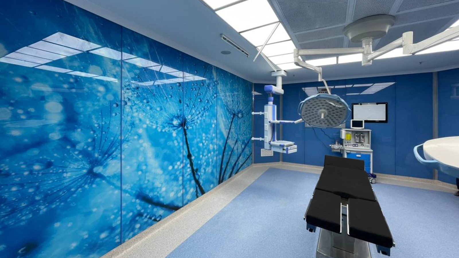 Operating room with graphic wall panels and a surgical table