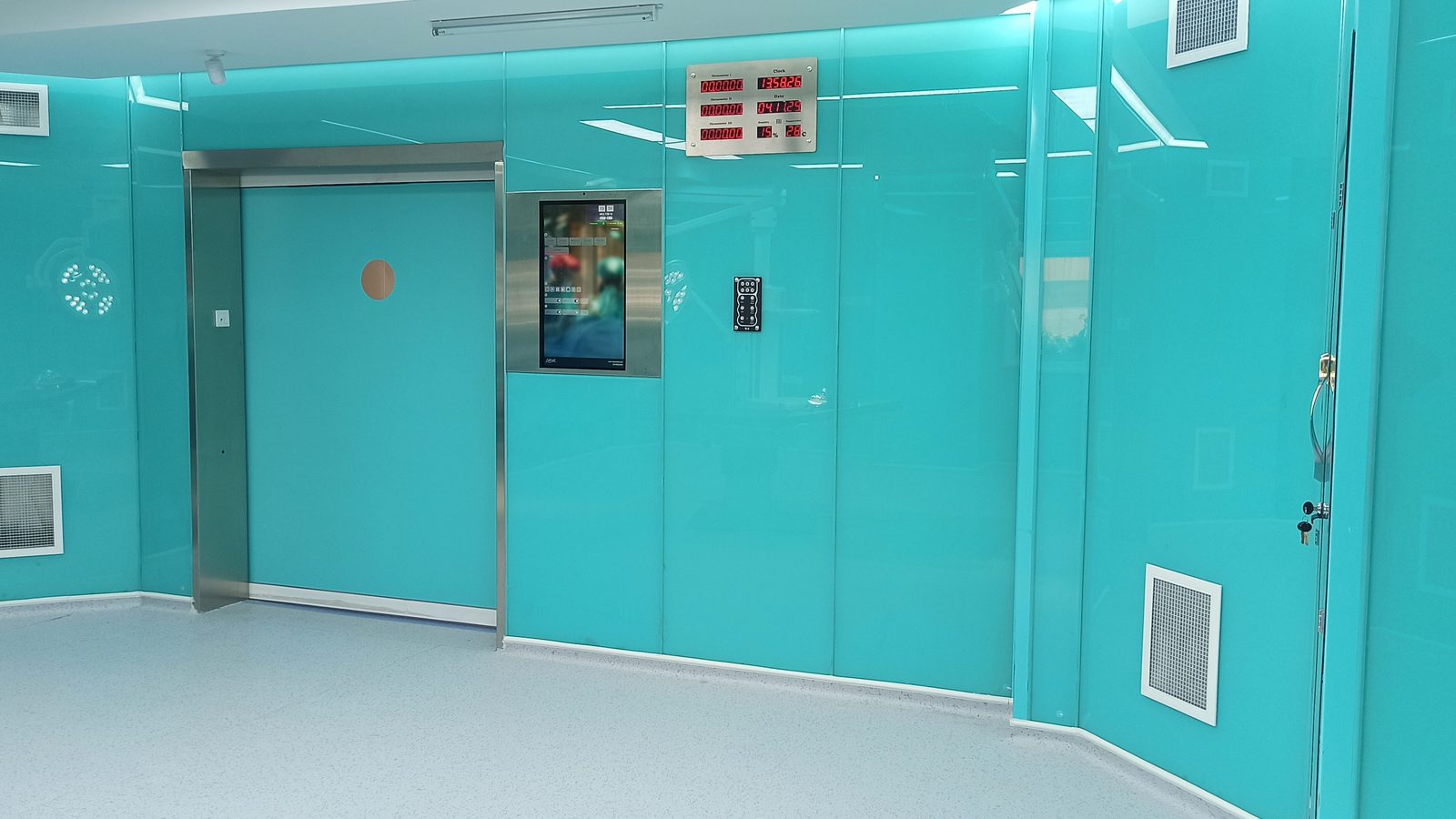Operating room entrance with sliding door and turquoise wall panels